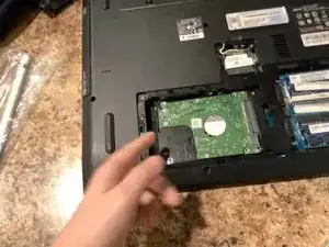 Lift up and then pull hard drive out