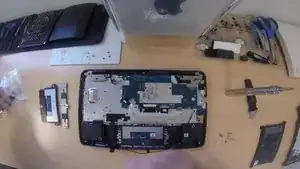 Install the second portion of the trackpad which is the small trackpad suspension bracket. This bracket gives the trackpad the "click" gesture.