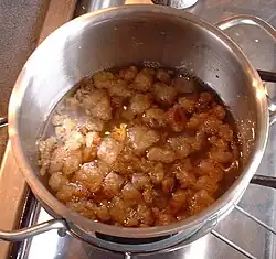 Cracklings floating in rendered fat