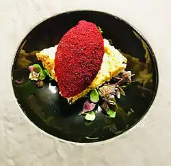 Plated dish, topped with a quenelle