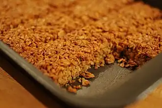 Slices of flapjack in a grey tray.
