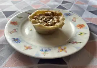 A maple butter tart served on a plate.