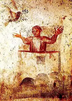 Orans - outstretched arms and palms up in a gesture of prayer