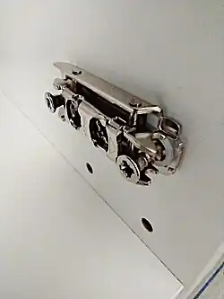 The base is always mounted with the two grippers facing you. This is where the hinge locks in.