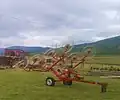 Wheel-finger rake (in folded transport position) for raking hay or straw into windrows for the baler