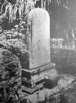 A black and white photo of a stele on a pedestal