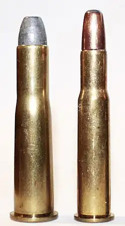 A .38-56 WCF cartridge next to a .30-30 Winchester cartridge