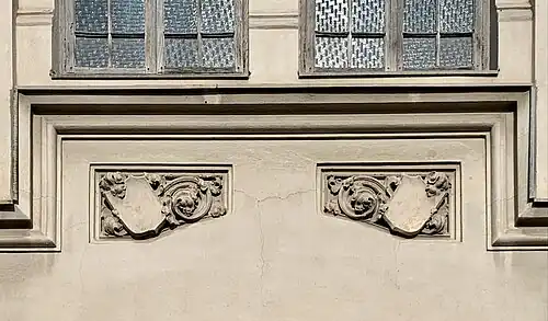 Gothic Revival shield-like cartouches on the Hermann I.Rieber carriage factory (Strada Romulus no. 17), Bucharest, by Siegfrid Kofczinsky, 1903[18]