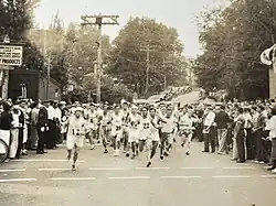 Black-and-white photo of men running
