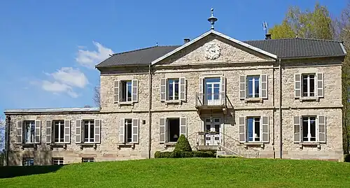 A Napoleon III-style manor house with pediment, balcony, upstairs terrace and numerous fireplaces.