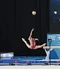 Performing a split leap under a thrown ball (Ekaterina Fetisova)