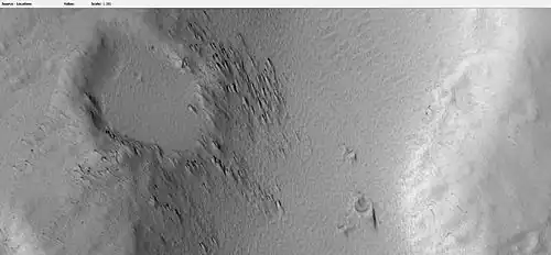 Crater on edge of lava flow on Hecates Tholus, as seen by HiRISE under HiWish program. Lava seems to have formed tail shape on the lee side of obstacles like crater rims.