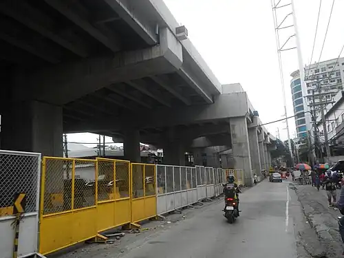 Steel pole 13 (of suspension or flag design, in the foreground) and 14 (of anchor or flag design, in the background) of the transmission line along the east side of the Gregorio Araneta Avenue