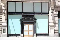 The Coty Building's ground-level storefront, with blue stickers covering all the windows and doors