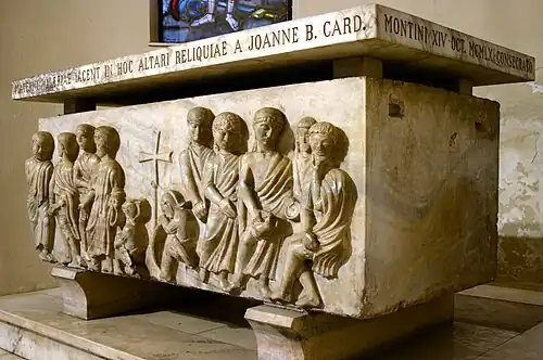 Photograph of a stone sarcophagus with several figures in high relief.