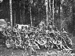 A group of weary soldiers in a jungle scene