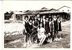 A teacher and her students outside of the school's garden