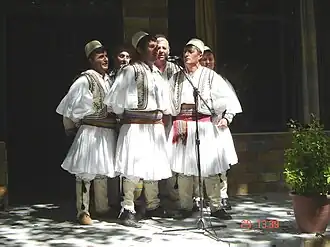 Albanian polyphonic group from Skrapar wearing qeleshe and fustanella