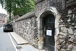 The medieval wall along the north side of the street which encloses College Garden