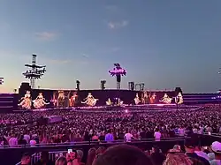 People watching an Adele show lit up with pink lights