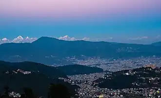 Nagarjun municipality with Tarakeshwar and Budhanilkantha in background.