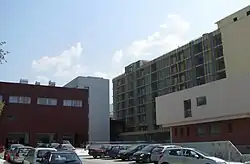 Partial view of the main multi-story building (under construction) and the new two-story building