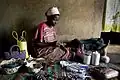 Annette Nandase, a beneficiary of the Beads of Hope Mbuya project, threads beads inside her home in the Mbuya district of Kampala, Uganda on 10 March 2009.