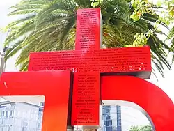 The other side of the large plus symbol with small writing on it.