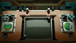 A desk with levers, buttons, and a monitor