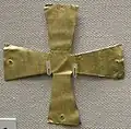 Plain gold cross, which indicates that the person buried was Christian