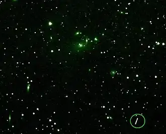 Asteroid Maria passing near a cluster of galaxies