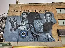 Mural depicting Mark Clark, Fred Hampton, and other members of the Black Panther Party.