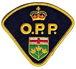 Black patch with the lettering O.P.P. embroidered in yellow, along with a section of the coat of arms of Ontario Canada.