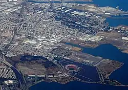 A bird's-eye view of the Bayview–Hunters Point neighborhood of San Francisco. Candlestick Park, demolished in 2015, is in the foreground.
