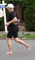 A barefoot runner on asphalt