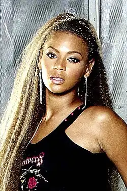 20-year-old Beyoncé in a black top, photographed looking directly at the camera