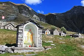 Image 19An "Alp" refers to a high elevation pasture frequented only in summer. It often includes several huts and small places of worship (here the Alpe Bardughè in Ticino). (from Alps)