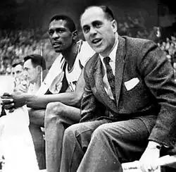 Bill Russell and Red Auerbach watching a game from the bench