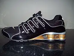 Black and gold Nike Shox