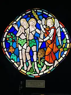 colorful glass showing an angel, a man, and a woman