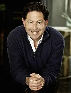 An approximately 48-year-old man looking and smiling at the camera.