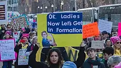 A poster with Rosie the Riveter saying the song's lyrics