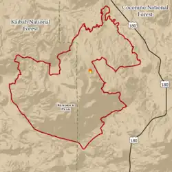 Jagged footprint of the fire is outlined in red, spanning parts of Kaibab and Coconino National Forests, west of U.S. Route 180
