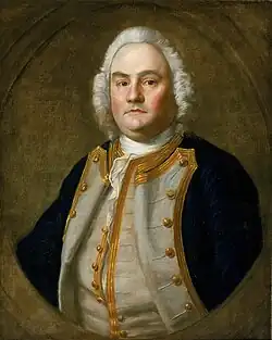 Portrait of a white male wearing a blue uniform coat with white lining and gold edges
