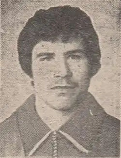 A black and white photo of a man with short dark hair and a mustache.