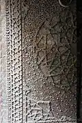 The metal doors of the mosque, with geometric and arabesque patterns.