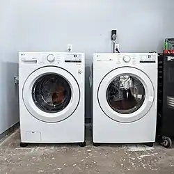 A picture depicting two front-loading washing machines.