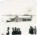 The station building visible above floodwaters, 1899.