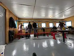 Inside a large fishing hut, group of 4 friendly families, from Montreal area