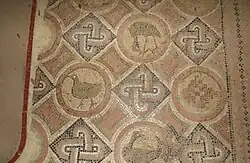 Detail view of a mosaic with birds and geometric motifs